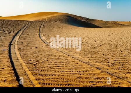 color image taken at dusk, abstract view of Tyre tracks through,the desert,