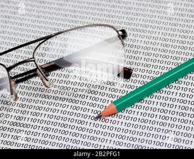 glasses and  pencil on the background of a binary code Stock Photo
