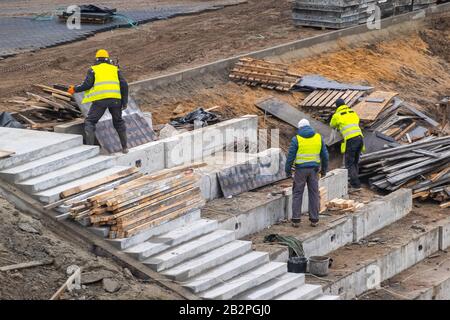 Builders working on construction foundation. Man strengthen concrete structure on the hill slope Stock Photo