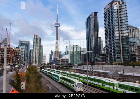 GO Transit Train rail depot seen with CN Tower and Rogers Centre in behind on sunny day. Stock Photo