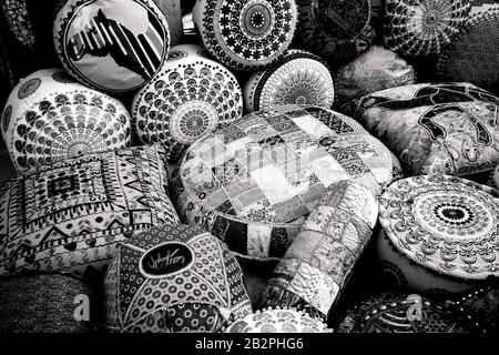 Black and white image of cushions/fabrics outside market stall in Old Town Dubai UAE Stock Photo