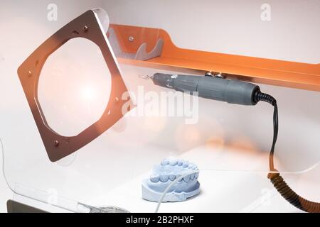 Dental technician or dentist workplace with tooth dentures  laboratory Stock Photo