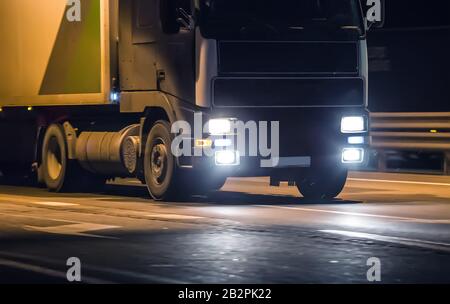 truck moves on country highway at night Stock Photo