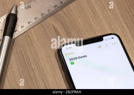 Smartphone notepad titled “2020 Goals” while placed on a desk. Stock Photo