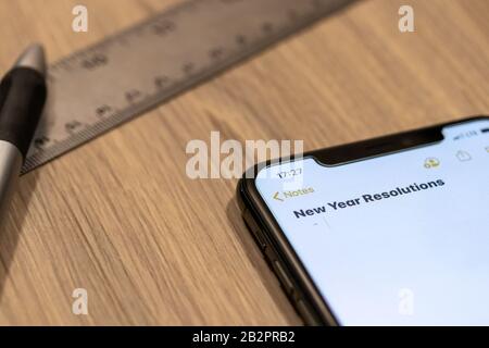 Smartphone notepad titled “2020 Goals” while placed on a desk. Stock Photo