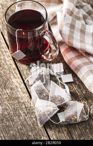 Floral tea bag on old wooden table. Stock Photo