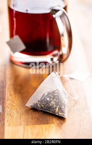 Floral tea bag on wooden table. Stock Photo
