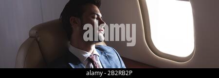 handsome businessman sleeping in plane during business trip Stock Photo