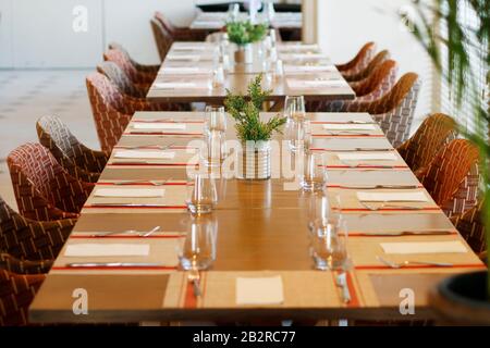 casual restaurant dining table set up, with dark wooden color theam Stock Photo