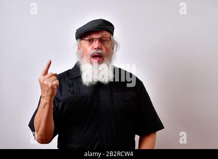 Man with an open mouth surprised pointing his finger up Stock Photo