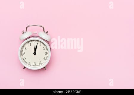 Retro alarm clock or vintage alarm clock isolated on pink background Stock Photo