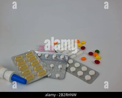 Nasal spray and tablets in different colours packed and loose Stock Photo