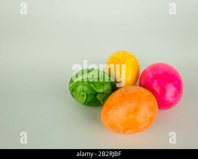 Four colourful painted easter eggs on a white background without decoration Stock Photo
