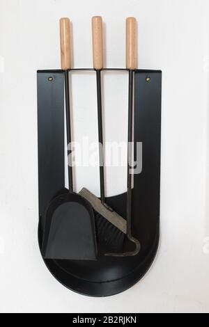 Broom shovel tongs as a set to clean and keep a stove clean Stock Photo