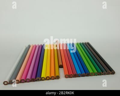 Coloured pencils in different colours arranged in a row Stock Photo