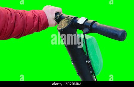 Electric scooter handlebar with on hand  isolated on green background Stock Photo