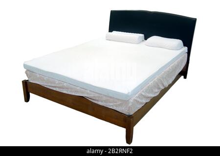 Modern double bed with cotton sheets and clipping path and rubber mattress Stock Photo