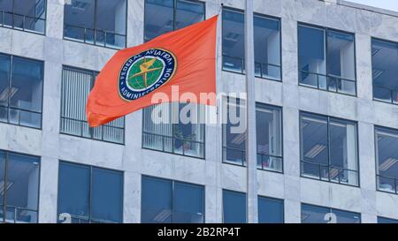Seal of the Federal Aviation Administration (FAA) on a waving flag out-front of the headquarters in Washington, D.C. Stock Photo