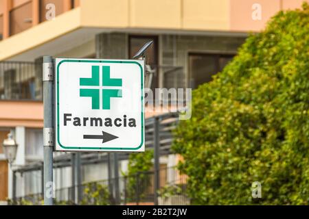 LAKE COMO, ITALY - JUNE 2019: Sign showing the way to a Pharmacy in one of the towns alongside Lake Como Stock Photo