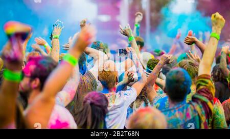 Montreal,Canada - Auguest 10 2019: People celebrate HOLI Festival throwing color powders in Horloge Park in Montreal Stock Photo