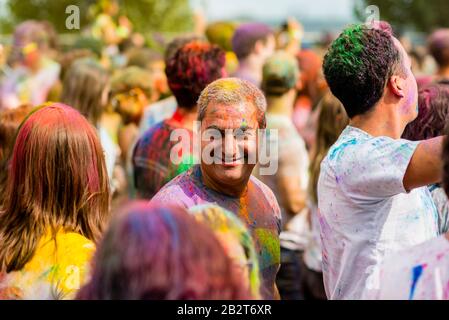 Montreal,Canada - Auguest 10 2019: People celebrate HOLI Festival throwing color powders in Horloge Park in Montreal Stock Photo