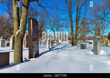 Montreal Quebec Canada march 1 2020: Old Cemetery with snow covered tomb stones on beautiful sunny day, Mount Royal Cemetery Stock Photo