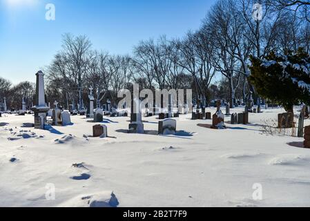 Montreal Quebec Canada march 1 2020: Old Cemetery with snow covered tomb stones on beautiful sunny day, Mount Royal Cemetery Stock Photo