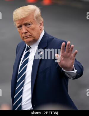 President Donald Trump waves before boarding Air Force One at Andrews