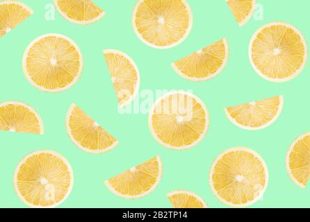 pattern with lemon slices on a light green background. Stock Photo