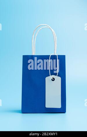 Blue shopping or gift bag isolated on blue background Stock Photo