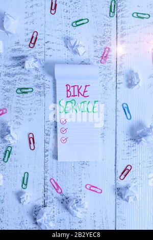 Conceptual hand writing showing Bike Service. Concept meaning cleaning and repairing bike mechanism to keep best condition Stripped ruled notepad clip Stock Photo