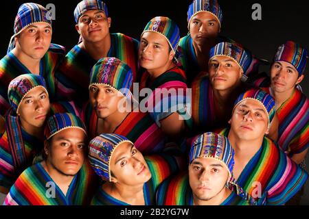 Ecuadorian Folkloric Group Dressed Up In Traditional Costumes Studio Shot. Stock Photo