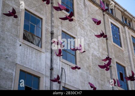 Decorative paper birds strung up in decorative commercial setting Stock Photo