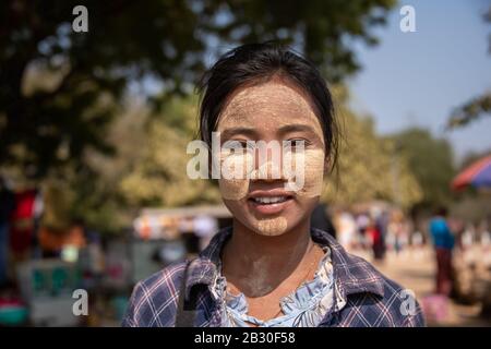 Bagan, Myanmar - 29 January 2020: Portrait of a young Burmese woman wearing Thanaka, a yellow cosmetic paste on her cheeks. Stock Photo