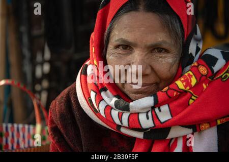 Chauk, Myanmar - January, 2020: Portrait of a beautiful woman with happy face and smiling eyes in a local marketplace. Stock Photo