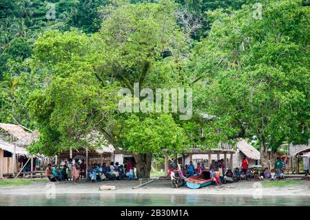 Villagers on Makira (Cristobal) Island, Makira-Ulawa Province, Solomon Islands await the arrival of a shore party from an expedition cruise. Stock Photo