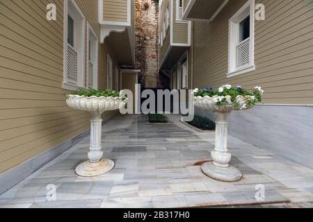 Interior in the courtyards and streets of houses of the old city of Vazy with flowers and a marble washbasin. Istanbul. Stock Photo