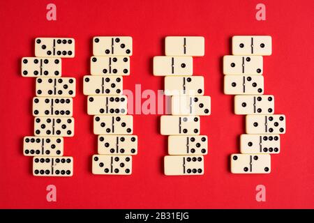 Playing dominoes on a red table. flat lay background. Stock Photo