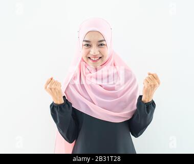 Half length portrait of asian beautiful Muslim young woman wearing business attire and hijab with mixed poses and gestures isolated on grey background Stock Photo