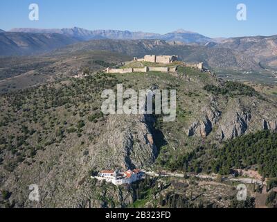 AERIAL VIEW. Castle on Larissa Hills overlooking a monastery. Argolis, Peloponnese, Greece. Stock Photo