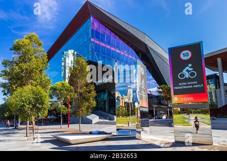 Pedestrian area at the Darling Harbour and a slow down bikes sign in Sydney, Australia. Stock Photo