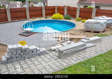 Swimming pool under construction, replacing interlocking pavement in rural country house Stock Photo