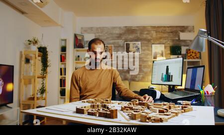 Young architect using augmented reality holograms for his building models. Stock Photo