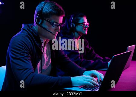 Caucasian man and a woman working late in an office Stock Photo