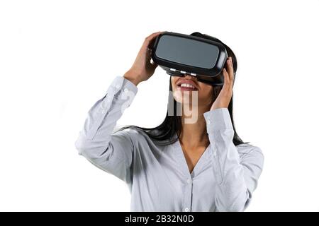 Mixed race business woman wearing a Virtual Reality headset Stock Photo
