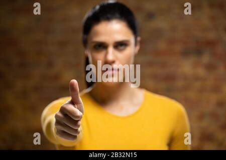 Caucasian woman with arm raised Stock Photo