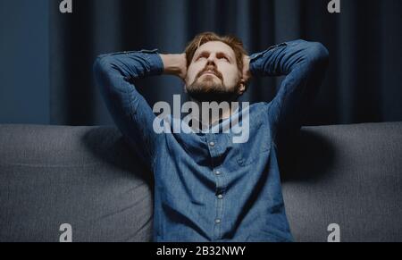 Man holding head looking up Stock Photo
