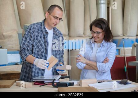 Carpentry workshop, workers discussing furniture production Stock Photo