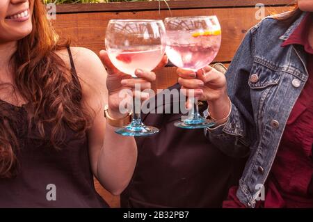 Woman drinking pink gin in summertime Stock Photo