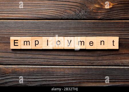 Employment word written on wood block. Employment text on wooden table for your desing, Top view concept. Stock Photo